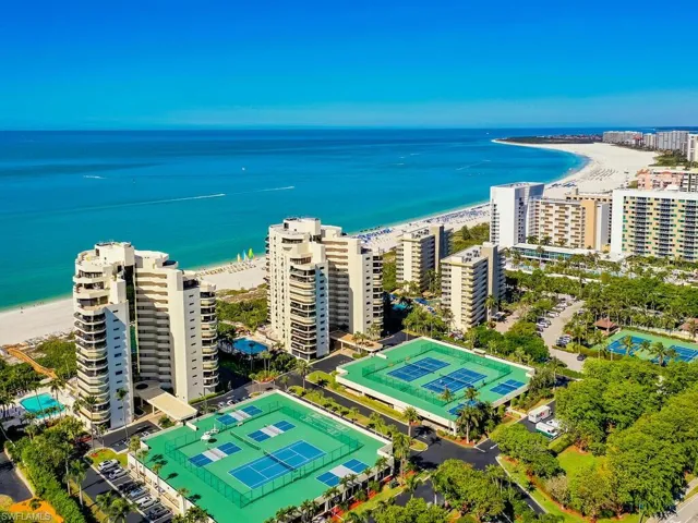 Aerial view with a water view and a view of the beach