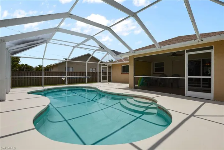 View of pool with a patio and ceiling fan