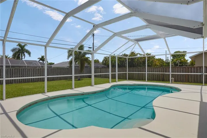 View of pool with a fenced backyard, a patio area, and a lanai