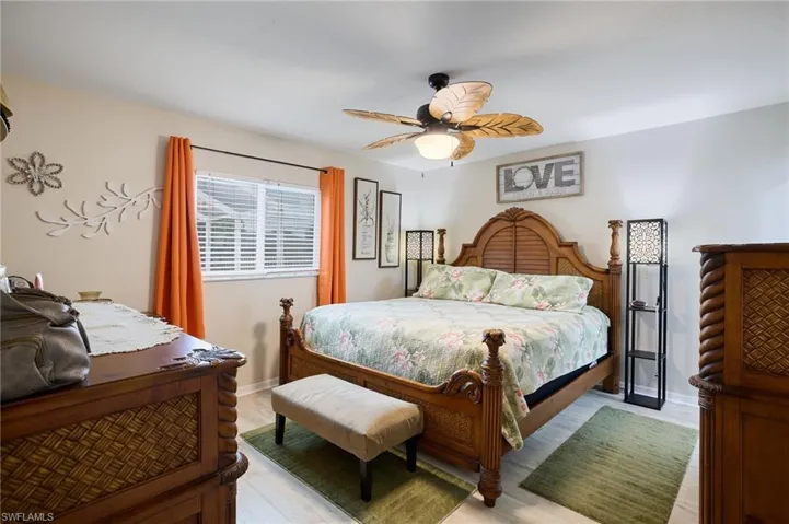 Bedroom featuring ceiling fan and baseboards