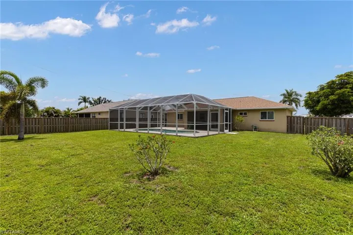 Fenced backyard with glass enclosure