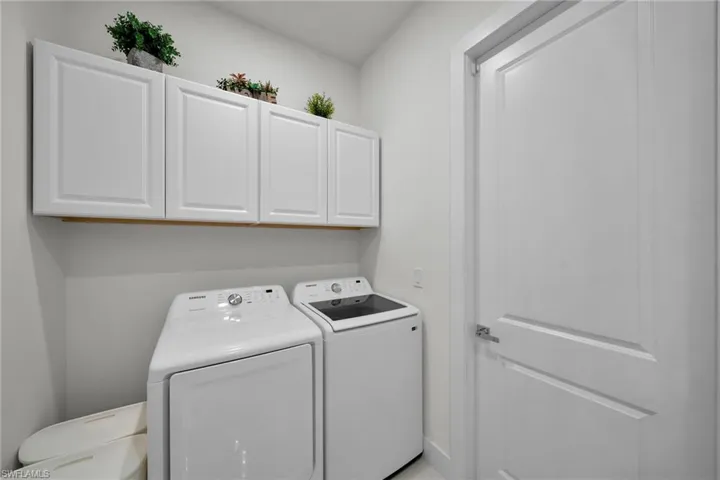 Laundry area featuring washing machine and clothes dryer