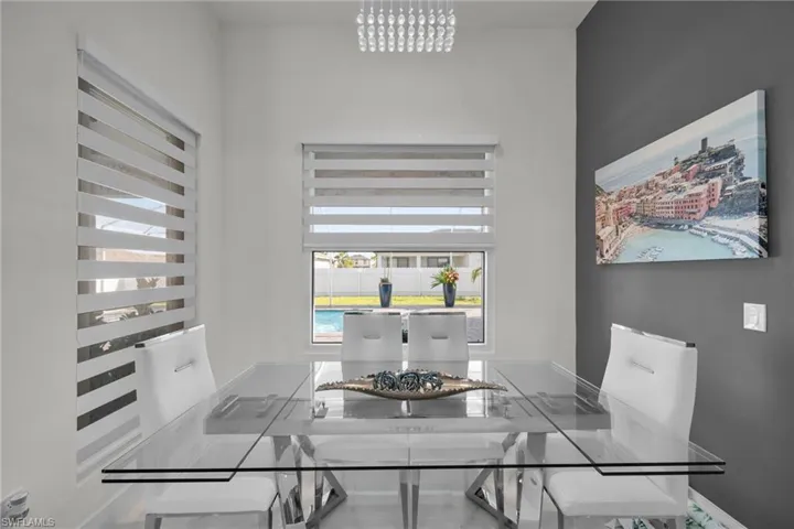 Dining space with baseboards and a chandelier
