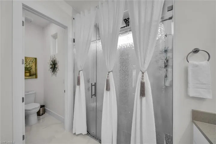 Full bathroom with a shower stall and toilet