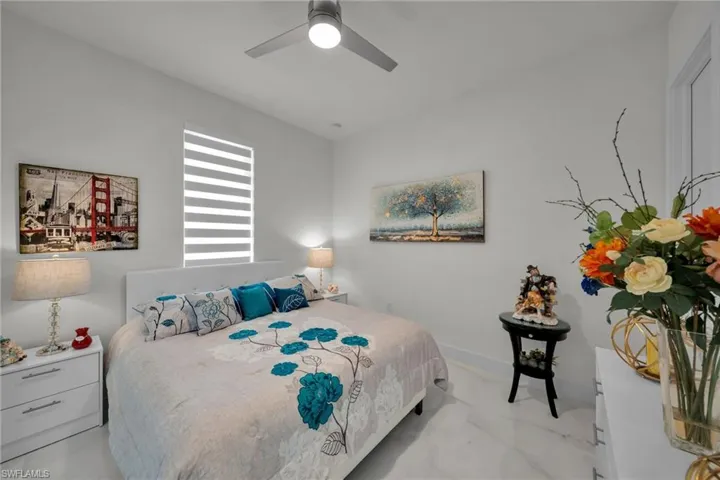 Bedroom with a ceiling fan and baseboards