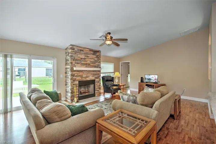 Family room features impact sliders to the backyard patio and a fireplace for the cooler months.