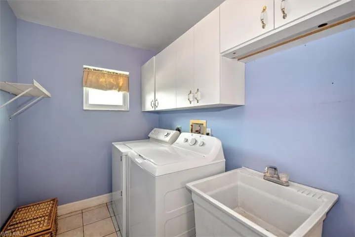 Large indoor laundry room with a laundry tub. Laundry tub water lines are not connected and was never used, but the drain is in place.