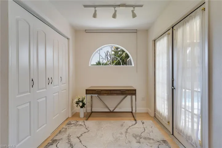 Foyer entrance featuring light wood-type flooring and rail lighting