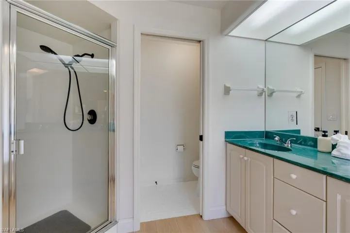 Full bath featuring a shower stall and vanity