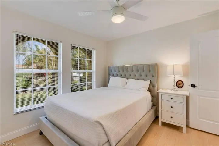 Bedroom with ceiling fan and light wood-style floors
