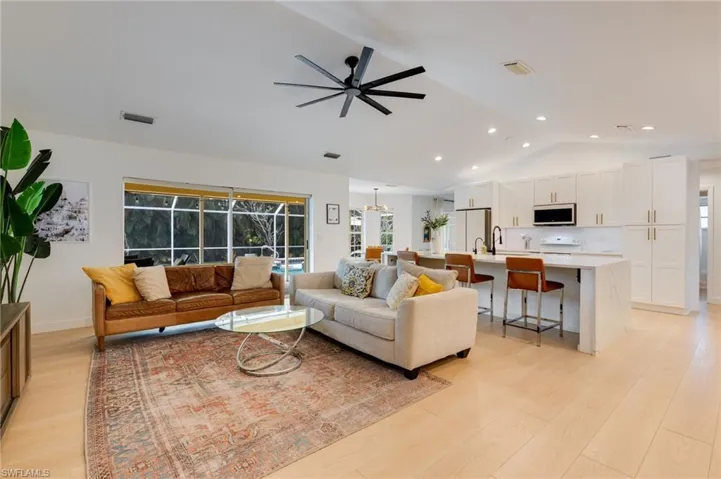 Living room featuring a ceiling fan, light wood-style floors, and recessed lighting