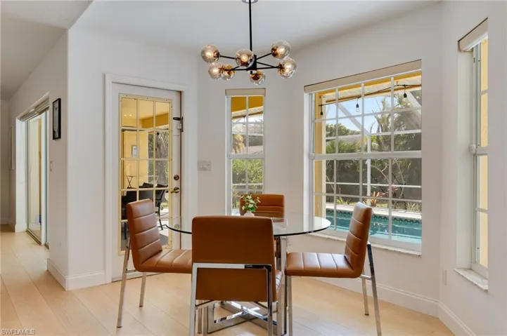 Dining room featuring suspended lighting and light wood-style floors