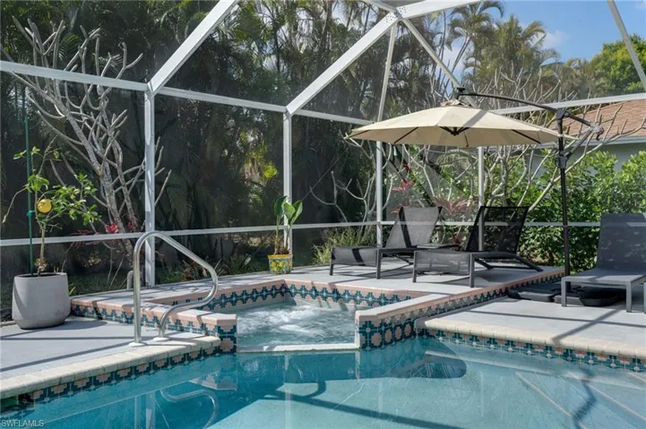 Outdoor pool with a lanai, a sunroom, and a patio area