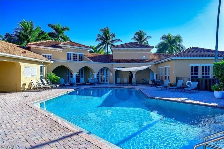 Community pool with a patio