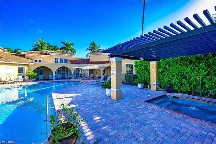 Community pool with a patio, a pergola, and a community hot tub