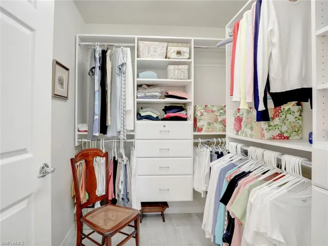 Spacious closet featuring hardwood / wood-style flooring