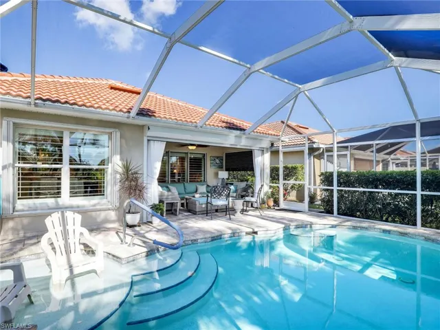 View of swimming pool featuring a patio, outdoor lounge area, and a lanai