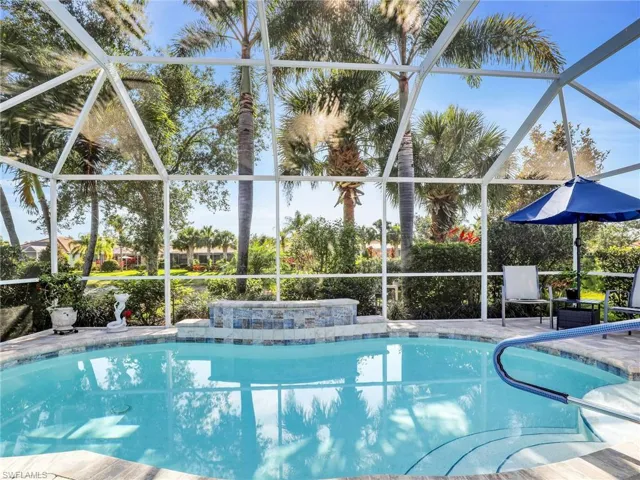 View of swimming pool with glass enclosure