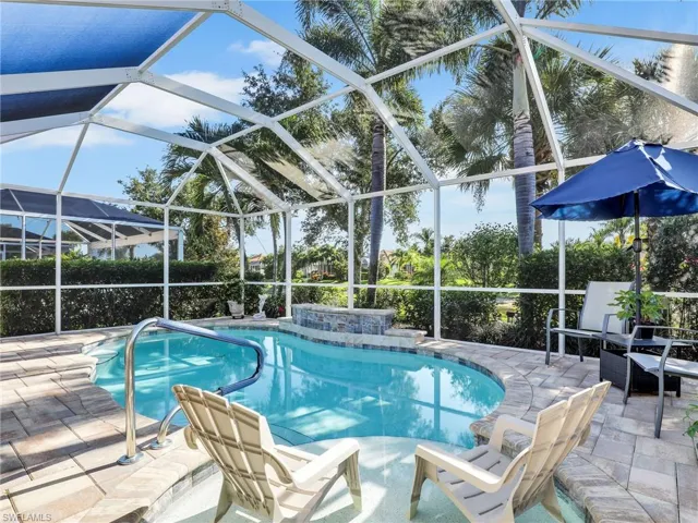View of swimming pool featuring a lanai and a patio area