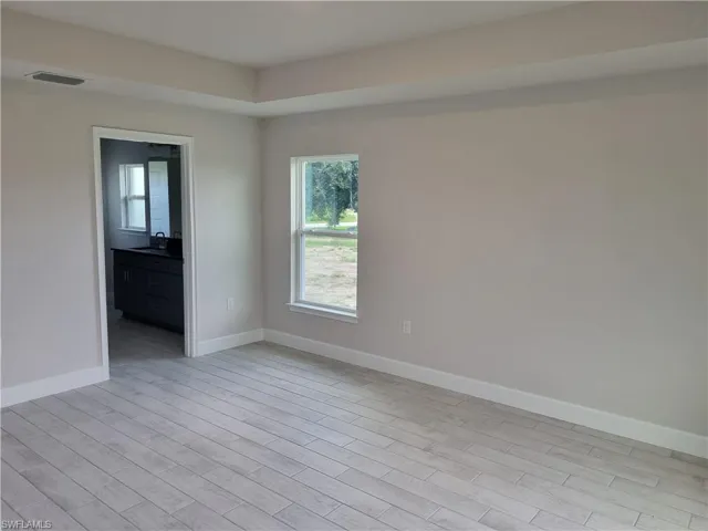 Unfurnished room with sink and light hardwood / wood-style flooring