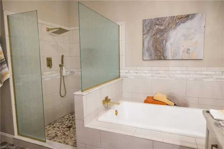 Bathroom featuring independent shower and bath