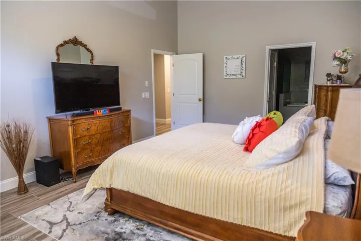 Bedroom featuring ensuite bath and light hardwood / wood-style flooring
