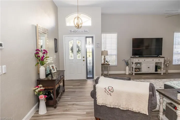 Entryway featuring an inviting chandelier and wood-type flooring
