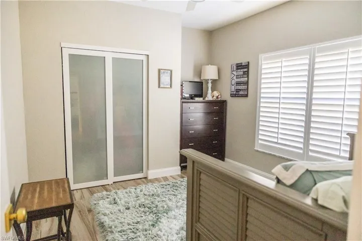 Bedroom with light hardwood / wood-style floors and ceiling fan