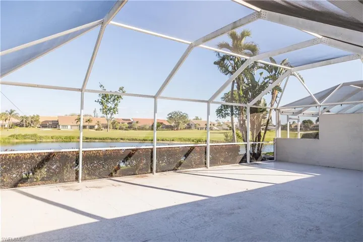 View of patio / terrace featuring a water view and a lanai