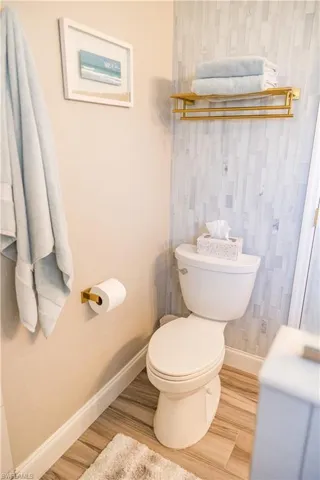 Bathroom with wood-type flooring and toilet