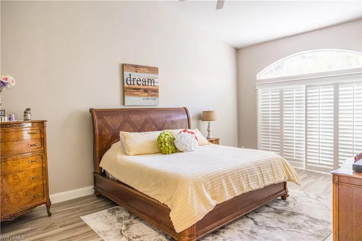 Bedroom with ceiling fan and light wood-type flooring