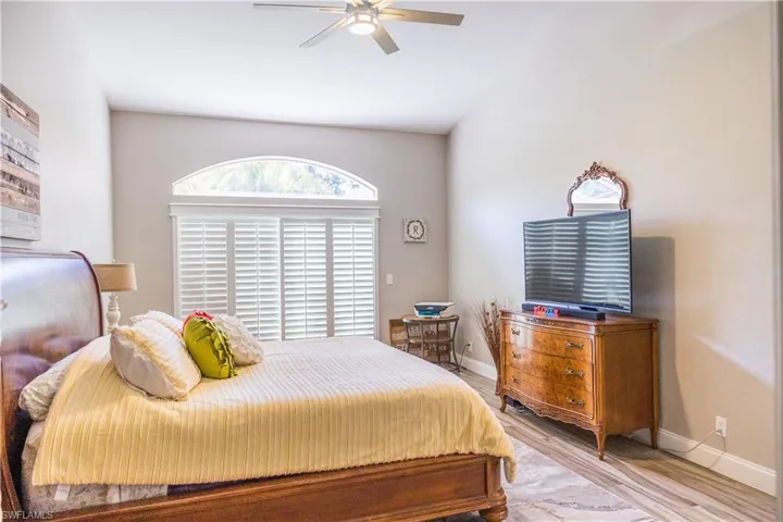 Bedroom with ceiling fan and light hardwood / wood-style flooring