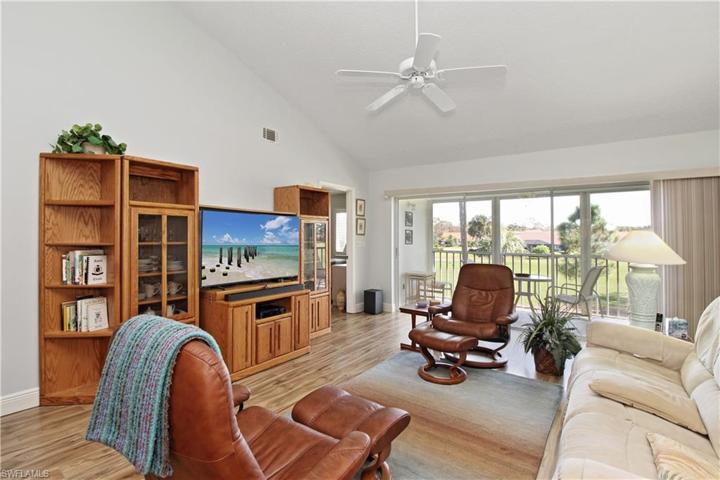Golf course view from living room. Double motorized Lazy Boy couch and 2 leather stressless chairs with ottoman foot stools offer comfortable space to watch TV . TV is only 2 years old.