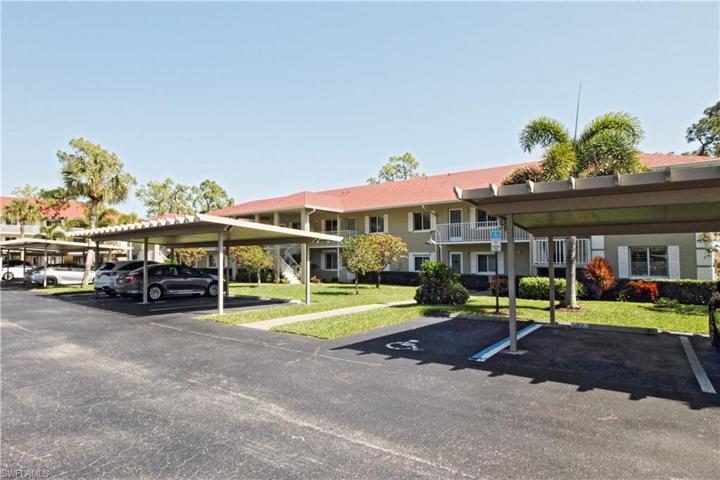Front of building with covered carport.