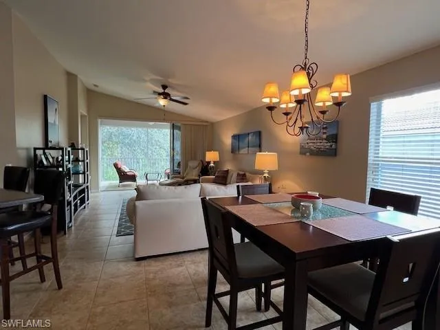 Tiled dining area with vaulted ceiling and lots of natural light.