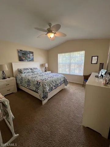 Spacious Guest Bedroom with volume ceiling and carpet floor.