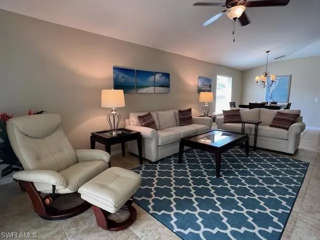 Enjoy entertaining in your Spacious and Bright Living Room with volume ceiling and tile floor open to the Dining Room and Kitchen.