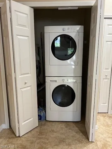 Laundry area with full size stacked washer / dryer