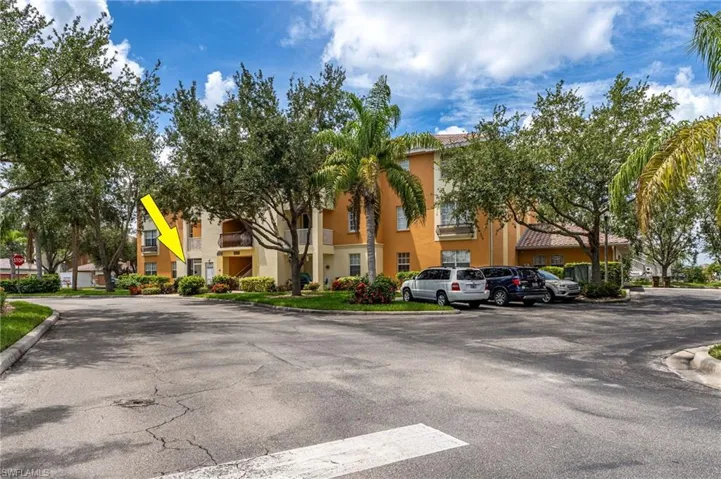 View of property with a residential view and uncovered parking
