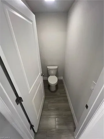 Bathroom with toilet and baseboards
