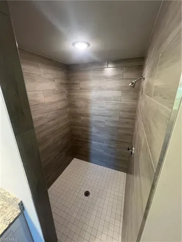 Full bath featuring tiled shower