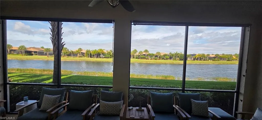Sunroom / solarium featuring a water view and ceiling fan