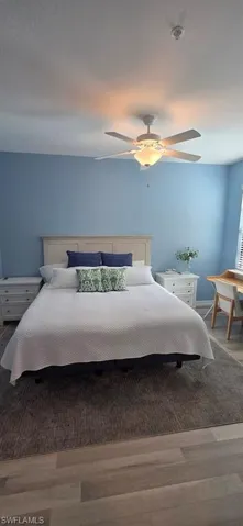 Bedroom with wood finished floors and a ceiling fan