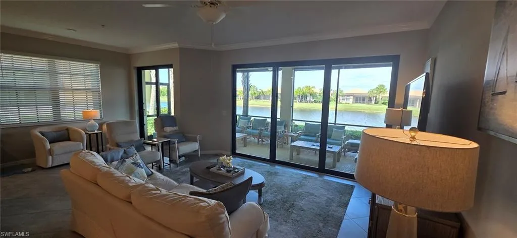 Living room featuring crown molding and a ceiling fan