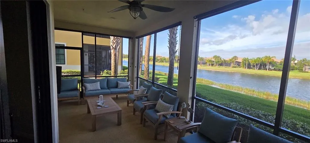 Sunroom / solarium with a water view and carpet