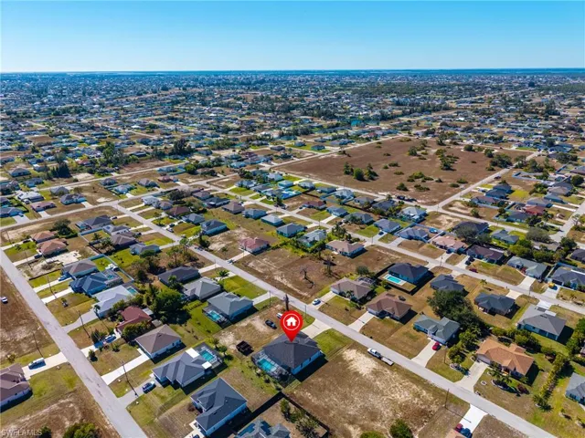 Aerial view of property's location featuring nearby suburban area