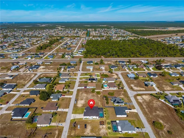Aerial overview of property's location with nearby suburban area