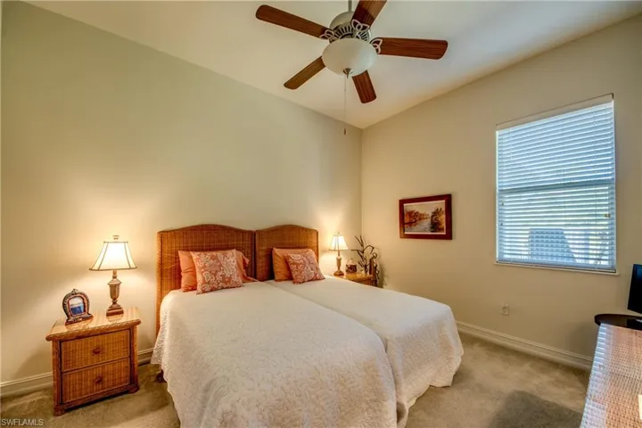 Bedroom with ceiling fan and carpet flooring