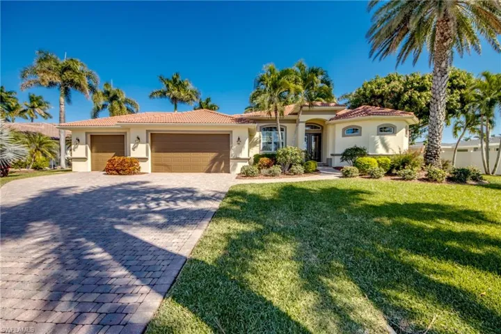 Mediterranean / spanish-style house featuring a tile roof, stucco siding, and a garage