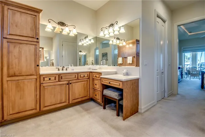 Full bathroom with light carpet, vanity, and suspended lighting